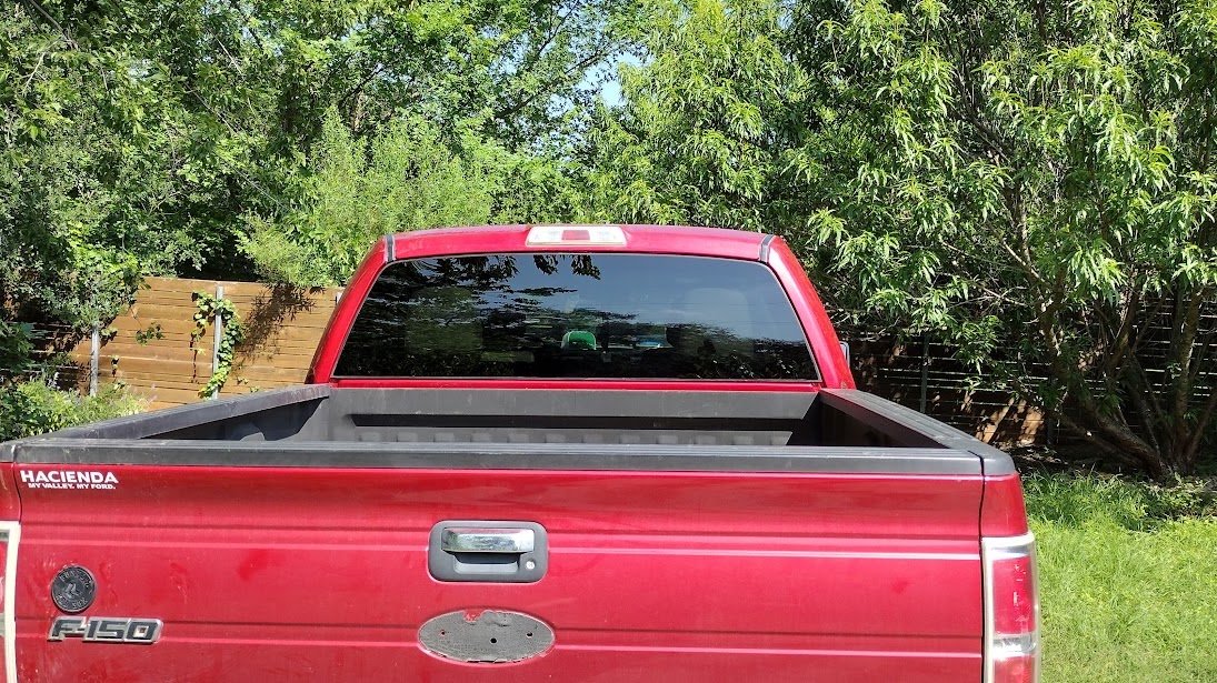 Red Ford F-150 with new back glass installed by J1 Auto Glass