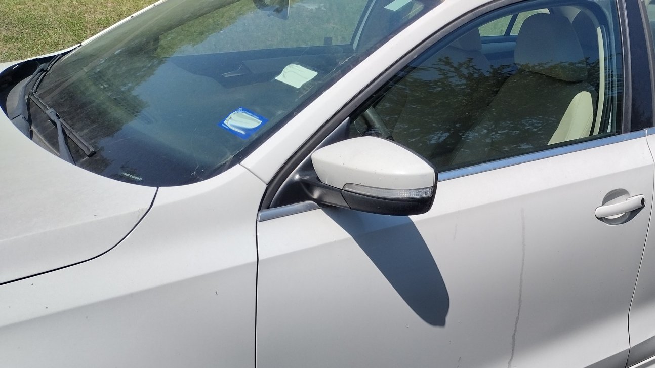 Silver sedan with a new side window installed by J1 Auto Glass