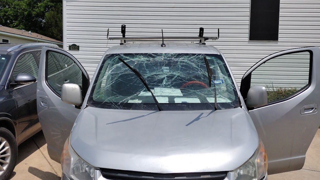 Shattered windshield on a silver Chevrolet before replacement